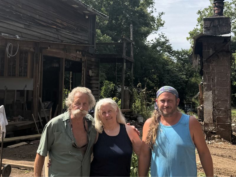 trio of people in front of home