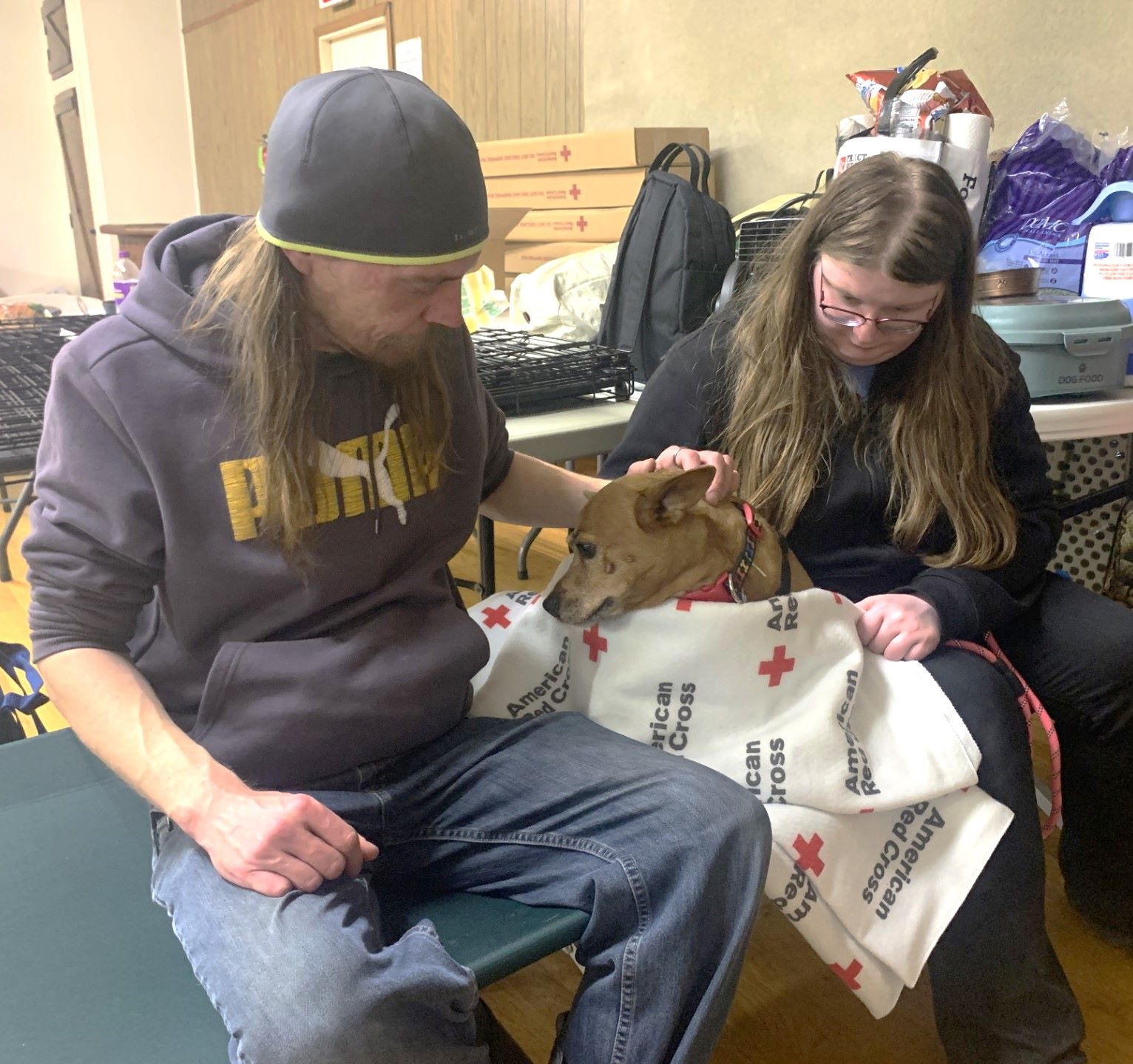shelter residents on bed with dog