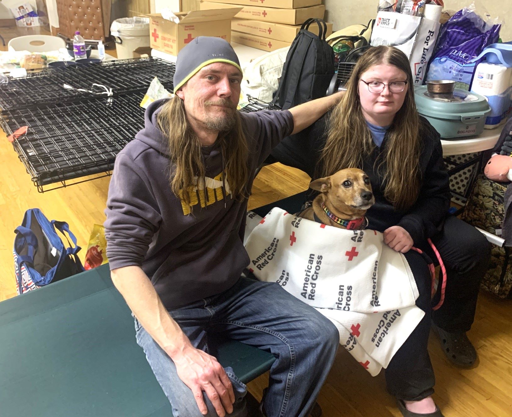 shelter residents on bed with dog