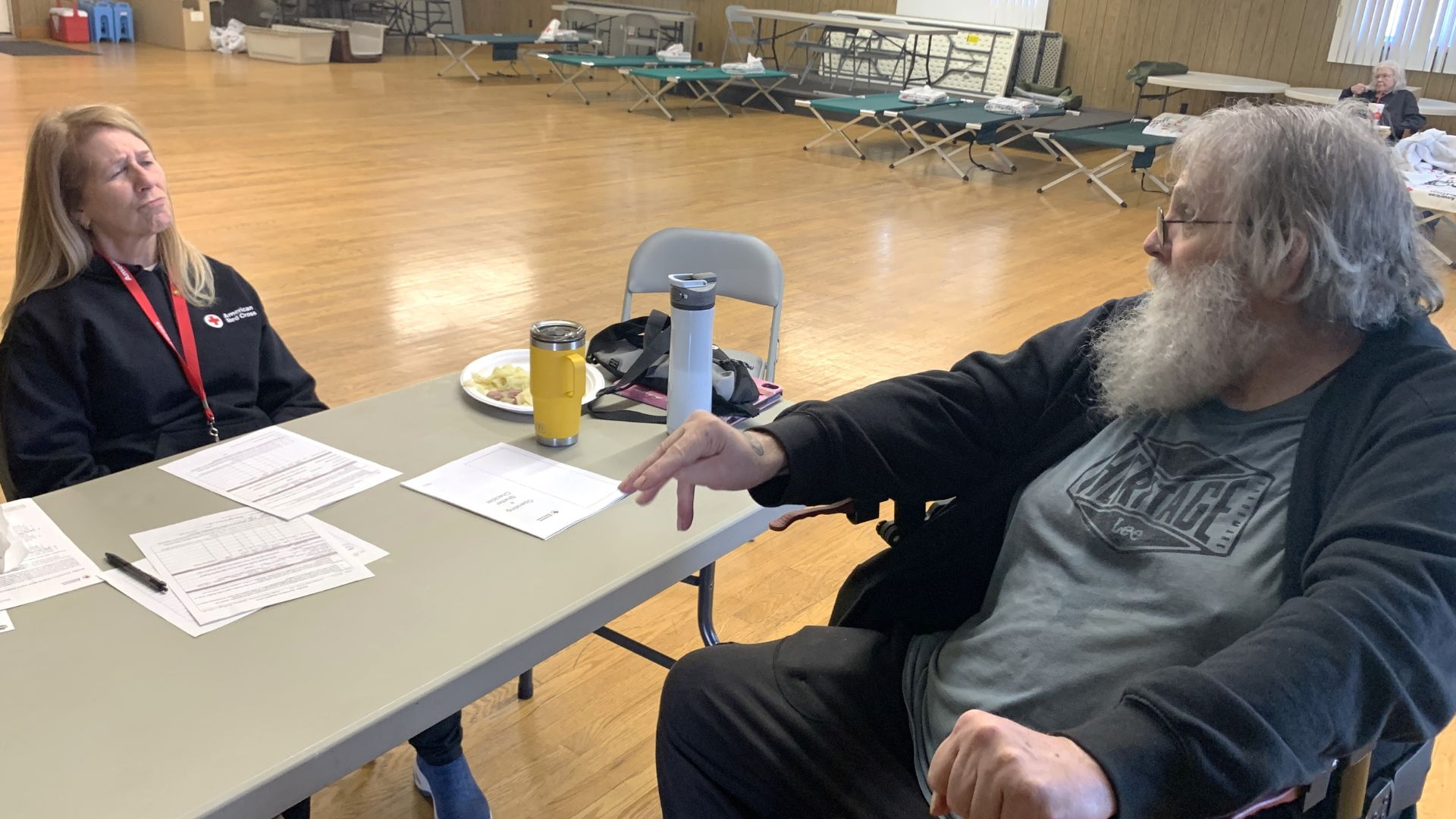 shelter resident speaking with red crosser
