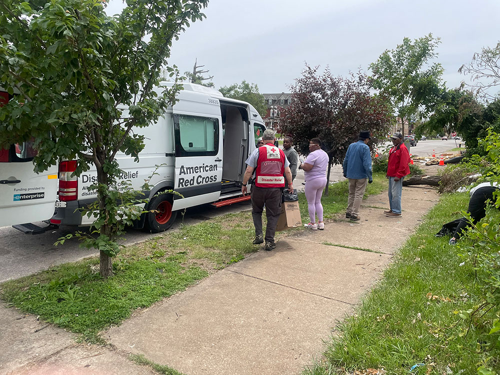 Residents line up to get hot meals from the Red Cross feeding station.