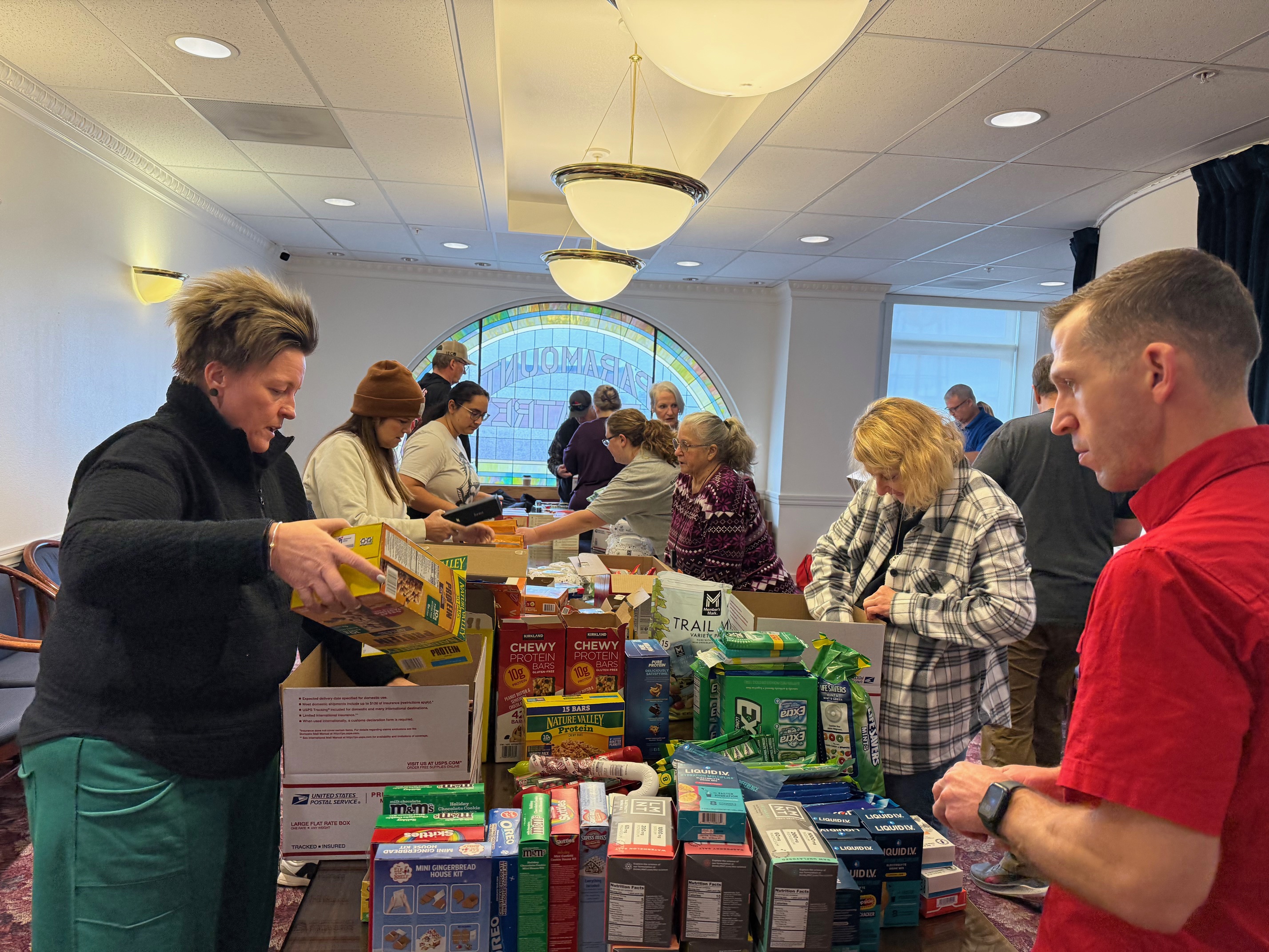 Red Cross volunteers teamed up with the Idaho Environmental Coalition to send holiday care packages to U.S. service members stationed in Qatar. The boxes, filled with treats, toiletries, and handwritten cards from local students, aim to bring comfort and a taste of home to troops thousands of miles away. 