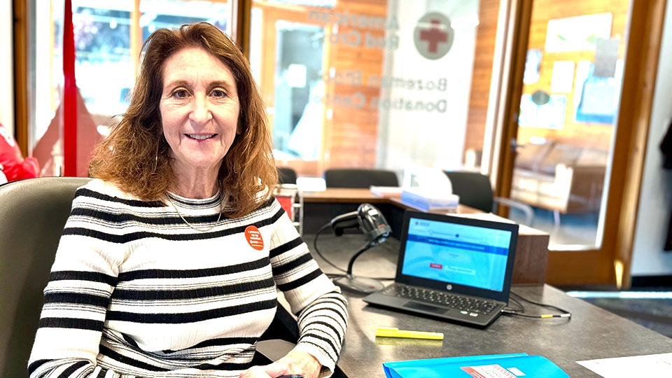  Dianne Click sitting at a desk in an office.
