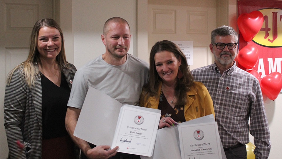 Montana Red Cross Executive Director Hannah Zuraff, left, and Board Chair Craig Stahlberg, right, present Red Cross Lifesaving Awards to Troy Rogge and Jennifer Hardwick.