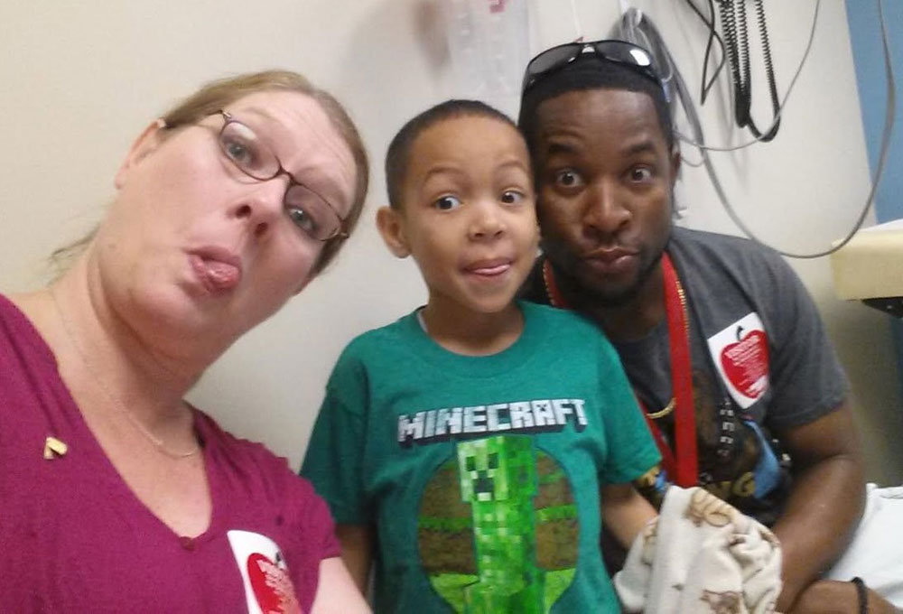 Trayson Harrell, with his dad Eric and mom Amy.