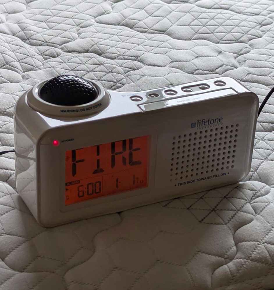 powered on bed shaker sitting on top of a bed.