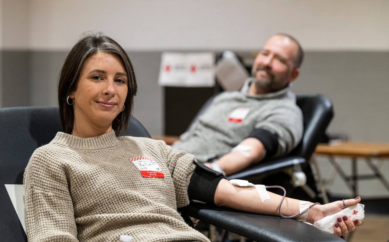 Kellie McNeave donates blood as her husband Shaun McNeave looks on, at a Chick -fil-A sponsored blood drive in Timonium, MD, on Nov. 27, 2024.  Photo by: Scott Marder / American Red Cross