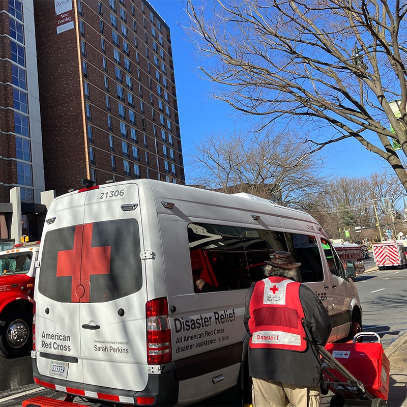 Red Cross volunteer in front of disaster relief van