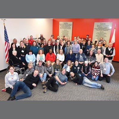 Group photo of Red Cross staff in room.