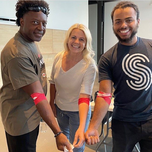 3 people showing bandage on arm from donating blood.