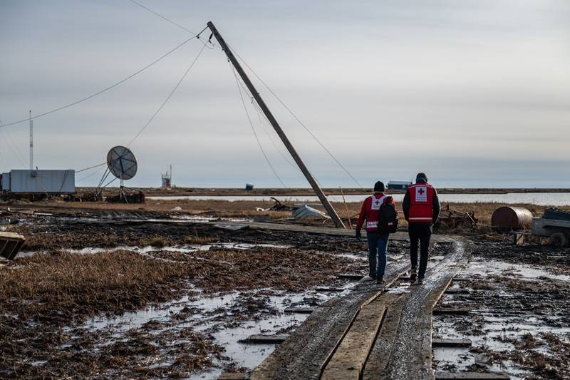 October 19, 2025. Kipnuk, Alaska.
Red Crosser Dale Kunce in the heavily-damaged village of Kipnuk, on Oct. 19, 2025.
The Red Cross is helping in Alaska as officials stage one of the largest airlifts in the state s recent history, evacuating entire villages that were left in ruins last weekend by Typhoon Halong. We are working with state, tribal, local officials and partners to support the evacuees who are being flown to shelters in Anchorage, where they will find a safe place to stay, food, emergency relief supplies, emotional support and health services. Hundreds of Red Cross disaster workers from across the country are being deployed to help during what could be a prolonged relief response with access to some villages cut off and others left uninhabitable as Alaska s winter sets in. 
Photo by Scott Marder/American Red Cross.