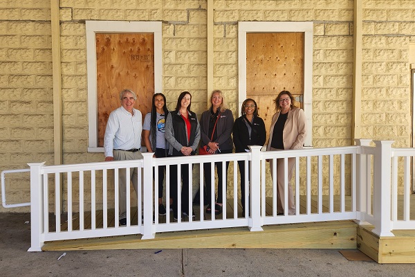 Rosie Taravella and members of the Community Adaptation Program standing on new ramp at the Friends of Jean Webster Food Pantry.