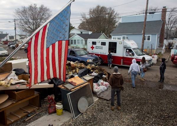 Superstorm Sandy 2012

November 4, 2012. Brick, N.J. Many residents of hard-hit areas like this neighborhood in Brick, N.J., that is without electricity, are getting meals, snacks and water from Red Cross feeding trucks while they drag the soaked contents out of their homes. As of Sunday, the Red Cross has served half a million meals and snacks to the victims of Hurricane Sandy across 16 states. Photo by Les Stone/American Red Cross

Red Crossers: Joe Mastrolia, Bud Manson, Jonathan Hammond
Recipient: Residents of neighborhoods hit by Hurricane Sandy are dealing with the effects of wind and flood damage and the loss of electricity
