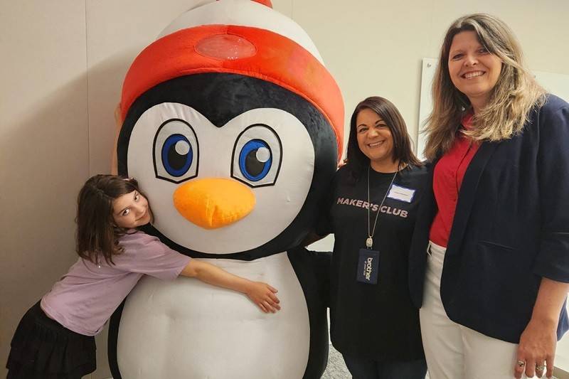 child hugs Pedro the Penguin in Bridgewater