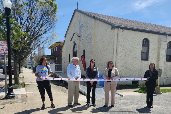 Red Cross New Jersey Region CEO Rosie Taravella and members of the Community Adaptation Program cut the ribbon on a CAP-funded ramp at the Friends of Jean Webster Food Pantry.