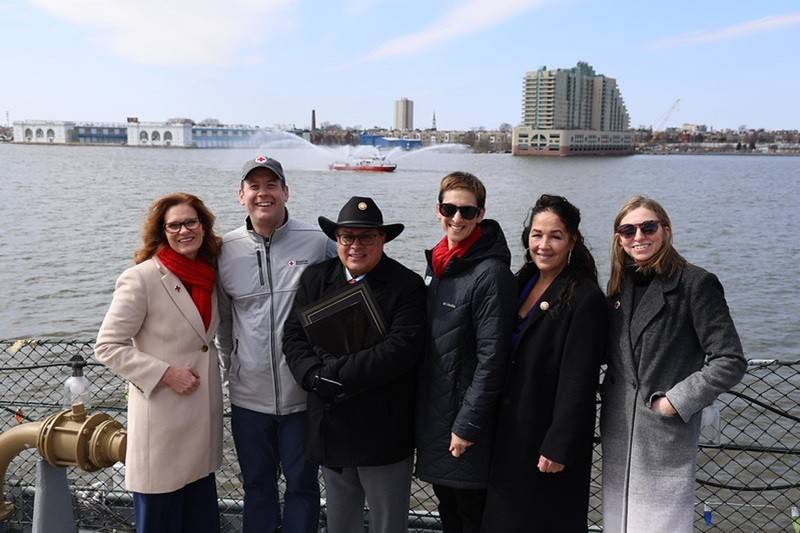 people with fire boat water display in Delaware River