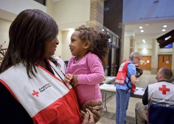 Superstorm Sandy 2012

November 8, 2012, Mahwah, New Jersey. One-year-old Nylah Stawder gets a hug from Red Cross volunteer Brenda Land , who flew in from Dallas to help out with Hurricane Sandy relief efforts, in a Northern New Jersey Shelter that took in victims of Hurricane Sandy from some of the hardest hit areas in NJ including Moonachie. Photo by Talia Frenkel/American Red Cross.