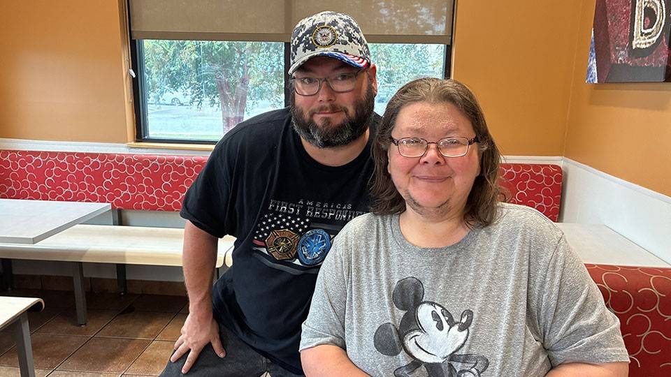 Jackie Wilkes and another person sitting in a restaurant.