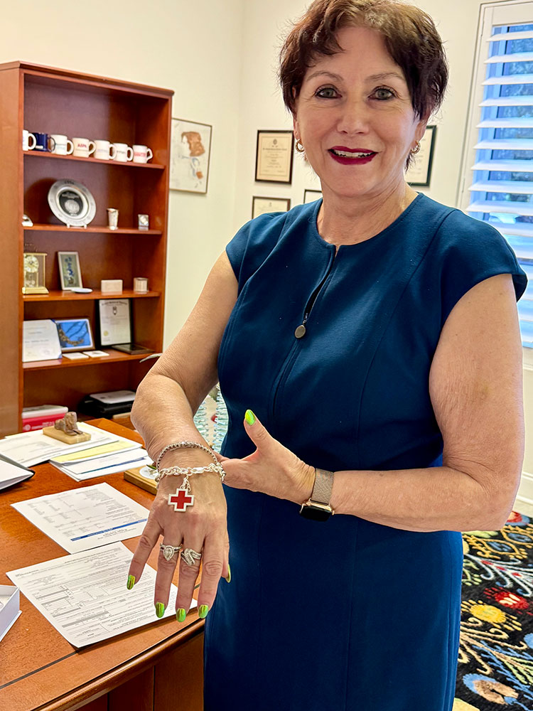 Lorraine Dorsa showing a Red Cross bracelet that's around her wrist.