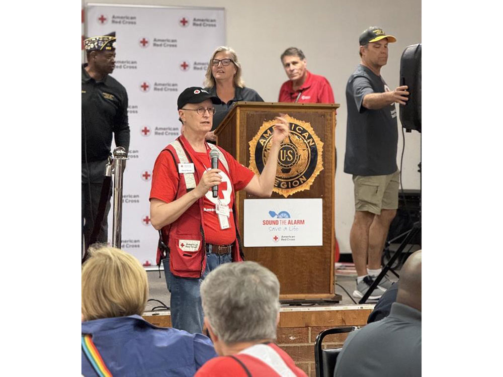 Commander Williams, CMAC Exec. Dir. Jason Gudzunas, Red Cross disaster teams, and Charlotte Fire in a room of volunteers for Sound the Alarm pre-training.
