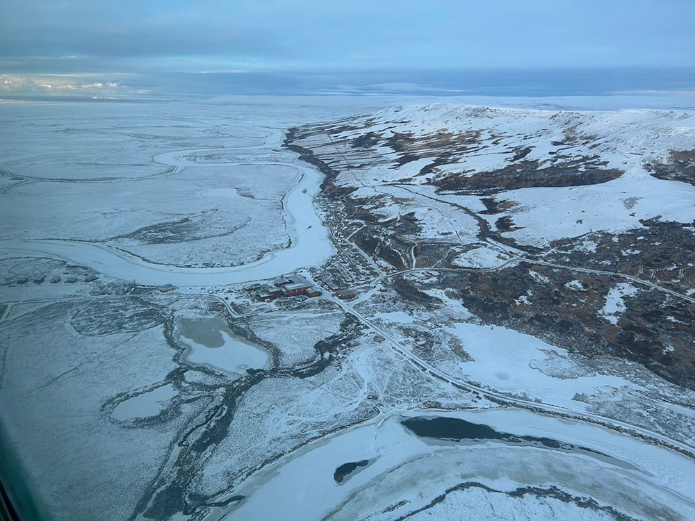 view from an airplane looking down at the snow covered landscape.