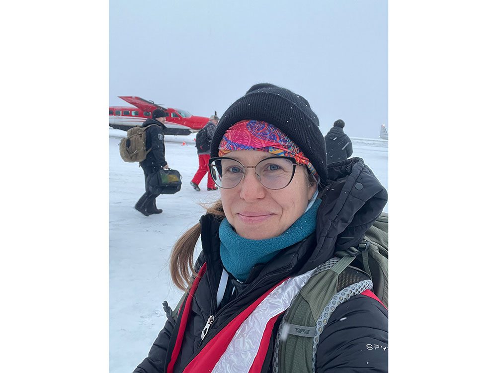 Red Cross volunteer in snow gear takes a selfie.