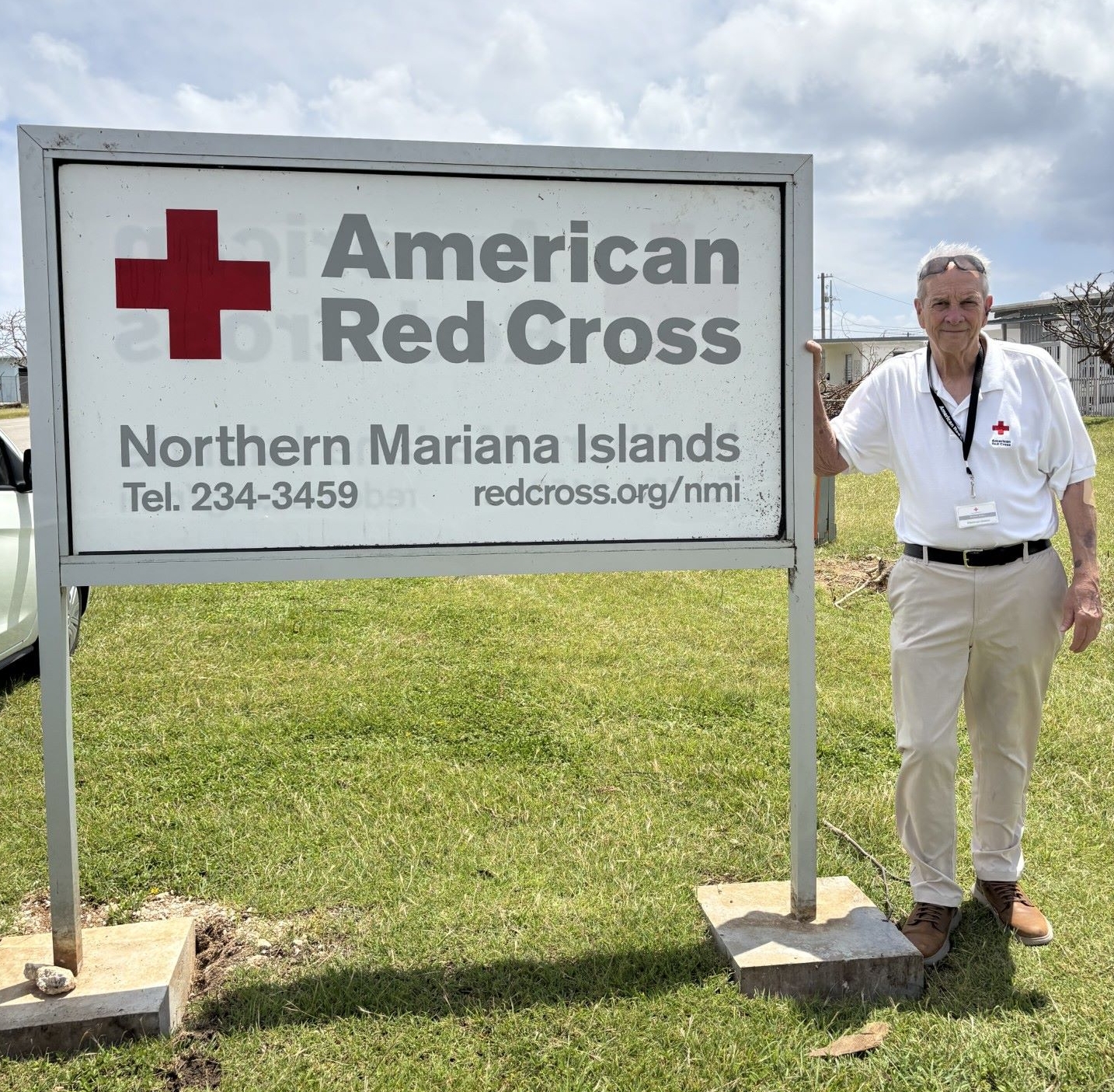 Steady Meres stands in front of a Red Cross sign in Saipan