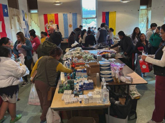 room full of people and tables with toiletries.