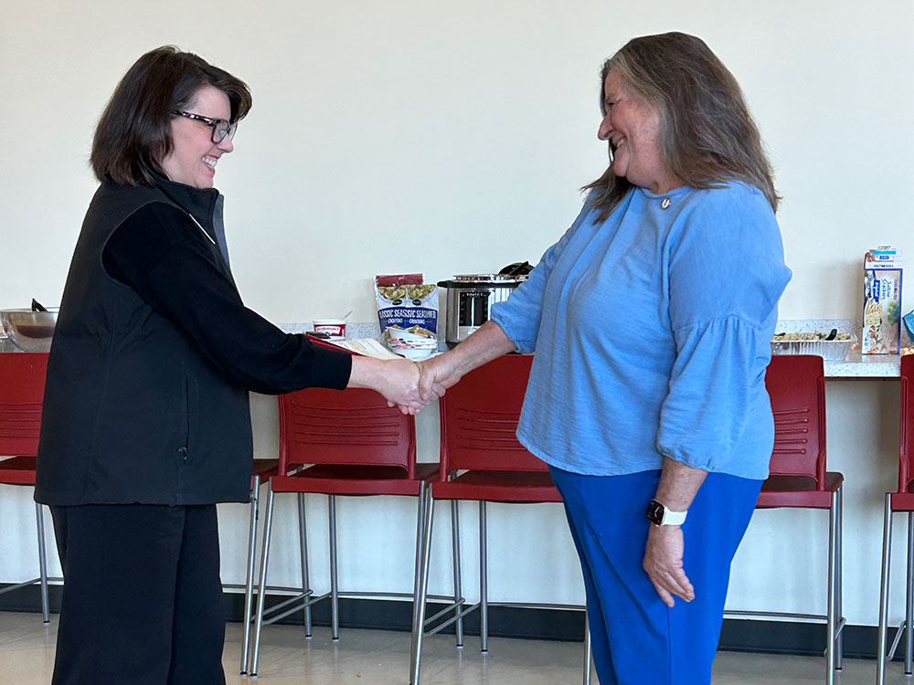 Lejeune High School Nurse shaking hands with a Red Cross employees.