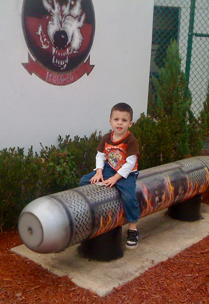 William Meyer sitting on a fake missle.