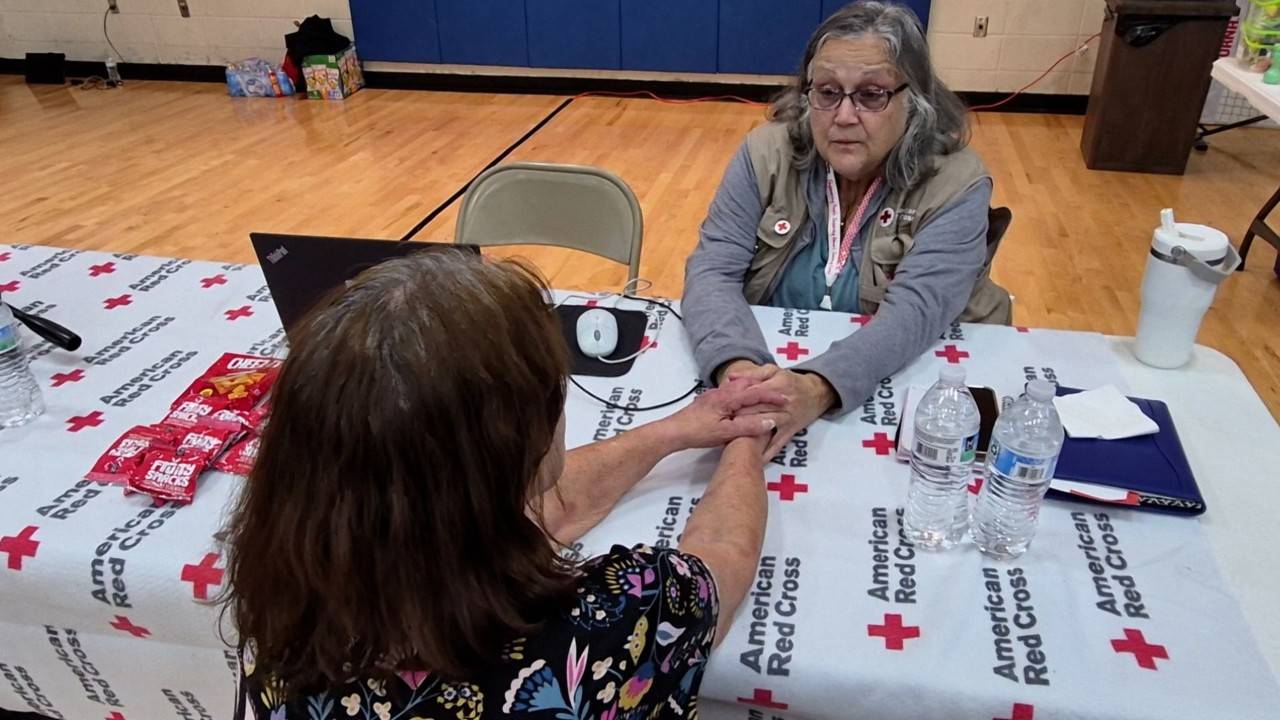 volunteer speaking with woman in shelter