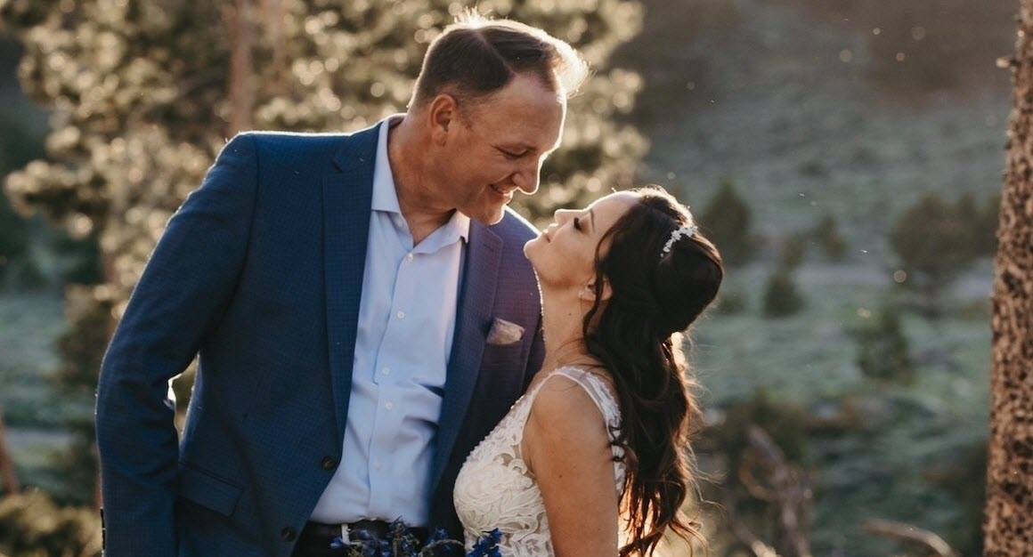 Alison Heidle in a wedding dress with her husband