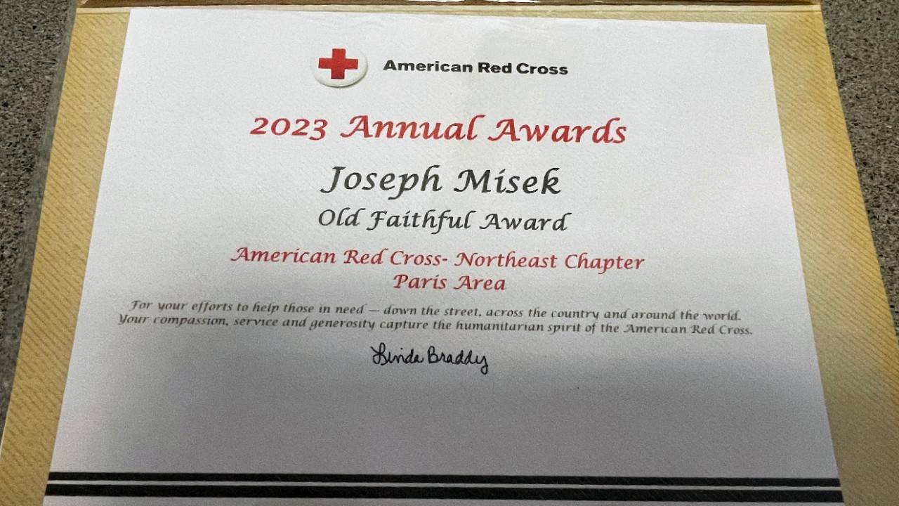 Joseph Misek, a 52 year Red Cross volunteer's "Old Faithful" Award.