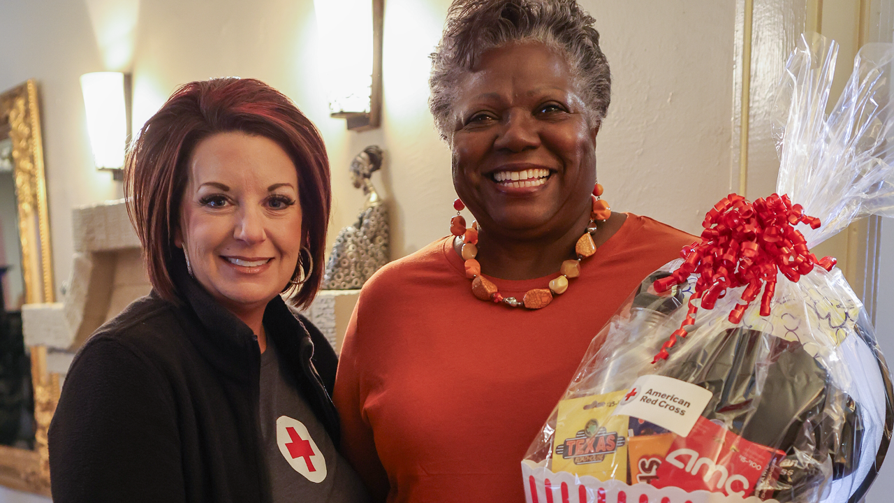 American Red Cross East Texas Chapter Executive Director Karen Holt and Tyler, Texas resident Merline Cash celebrate the installation of 50,000 free smoke alarms in the Red Cross North Texas Region at a Sound the Alarm event at Cash's home.