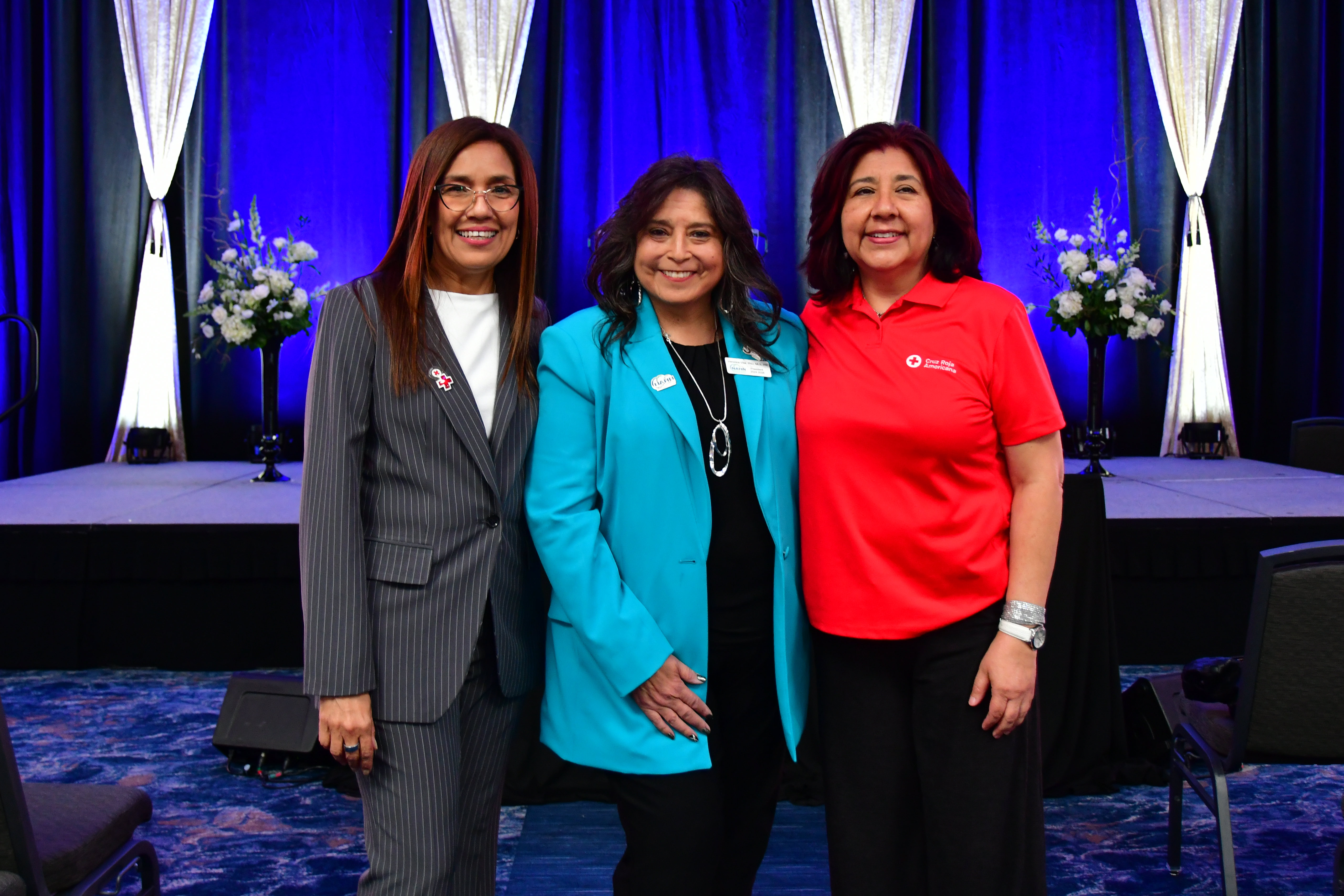 three women standing in front of banquet room