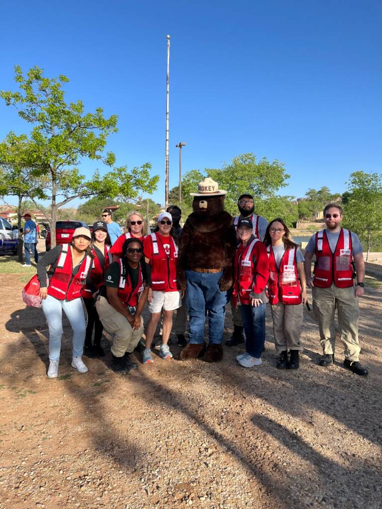 group photo of red cross volunteers and smokey the bear.