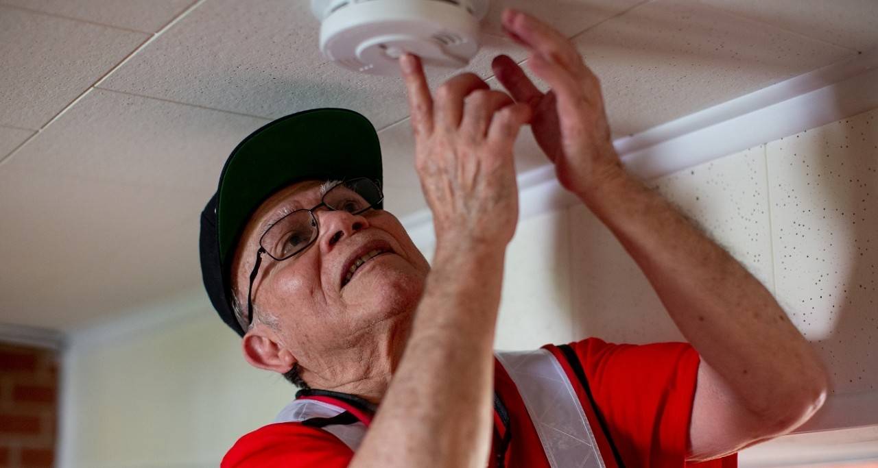 May 5, 2018. Raleigh, North Carolina.Smoke alarm installations at a Sound the Alarm event.Pictured: American Red Cross volunteer Domingo Reyes.American Red Cross volunteer Domingo Reyes installs a new smoke alarm in a home in Raleigh, North Carolina. The installation is part of the "Sound the Alarm" campaign. "Sound the Alarm" is a national home fire awareness campaign. As part of the effort to save more lives, teams of Red Cross and community volunteers go door-to door, installing the smoke alarms in private homes across the country. The goal is to install smoke alarms in as many homes as possible, and to educate families about how to prevent, and escape from, a home fire.All smoke alarms, installations, Escape Plans and safety information are provided at no cost to residents by the American Red Cross and its corporate and community partners.Photo by Adam Jennings for the American Red Cross.