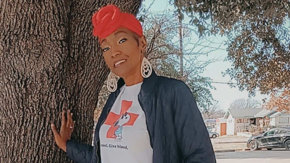 red crossers at information table with banners