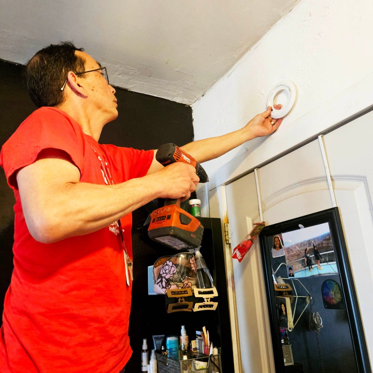 volunteer installing smoke alarm