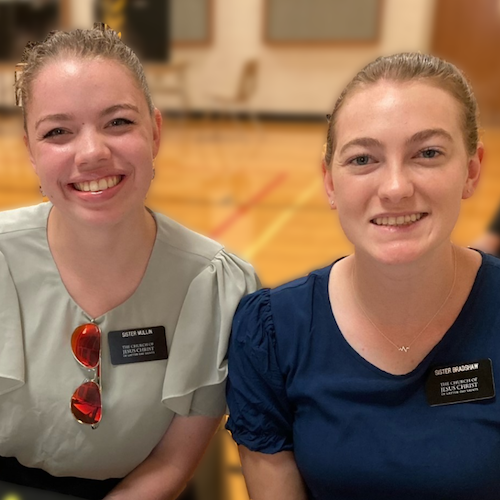 Two smiling female greeters at welcome table for Abilene blood drive