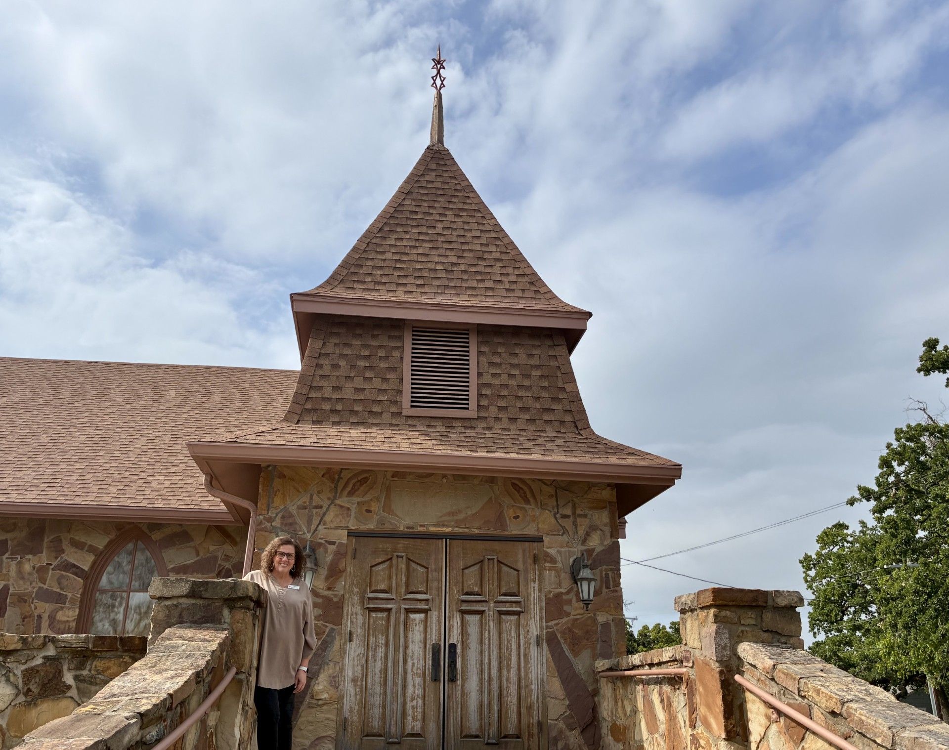 woman standing in front of church entrance