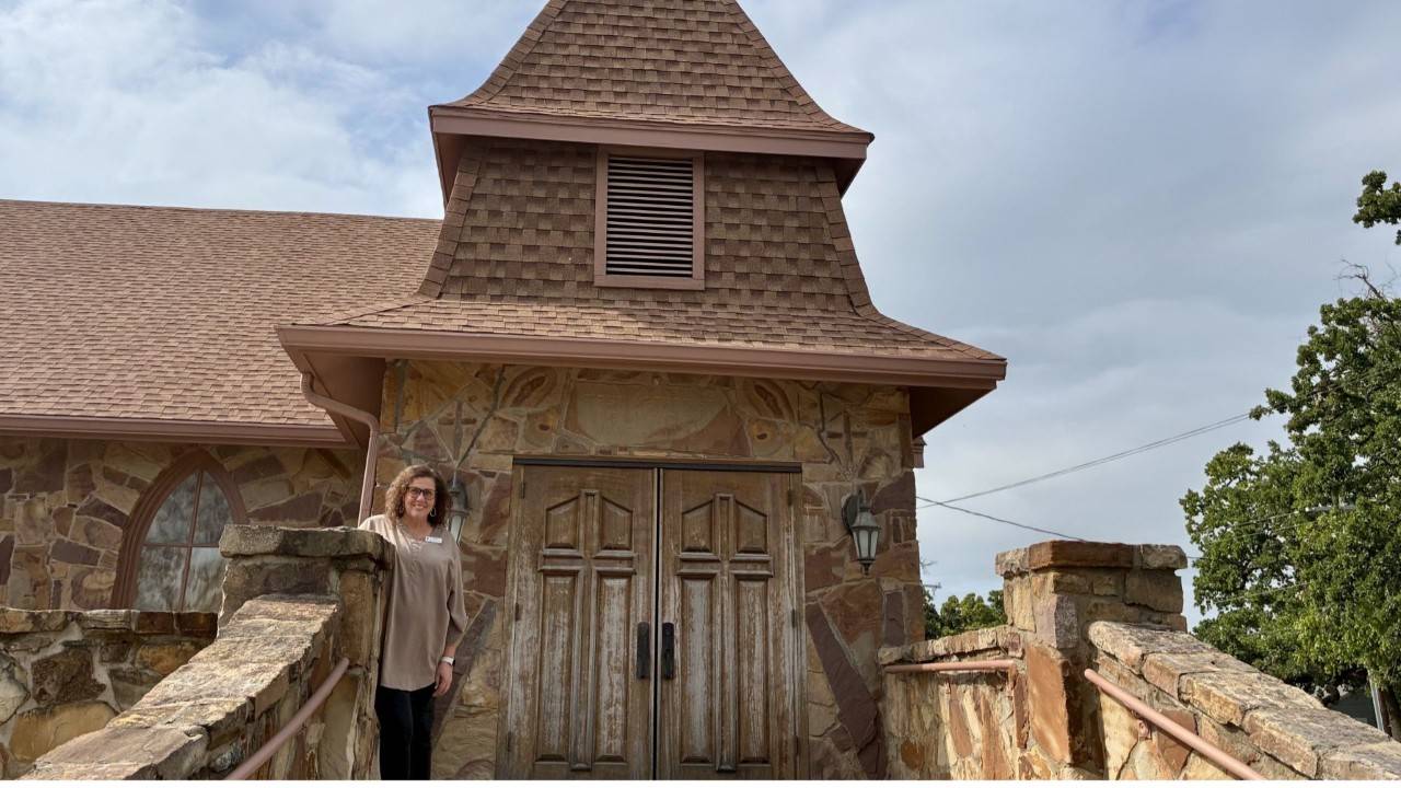 woman standing in front of church entrance