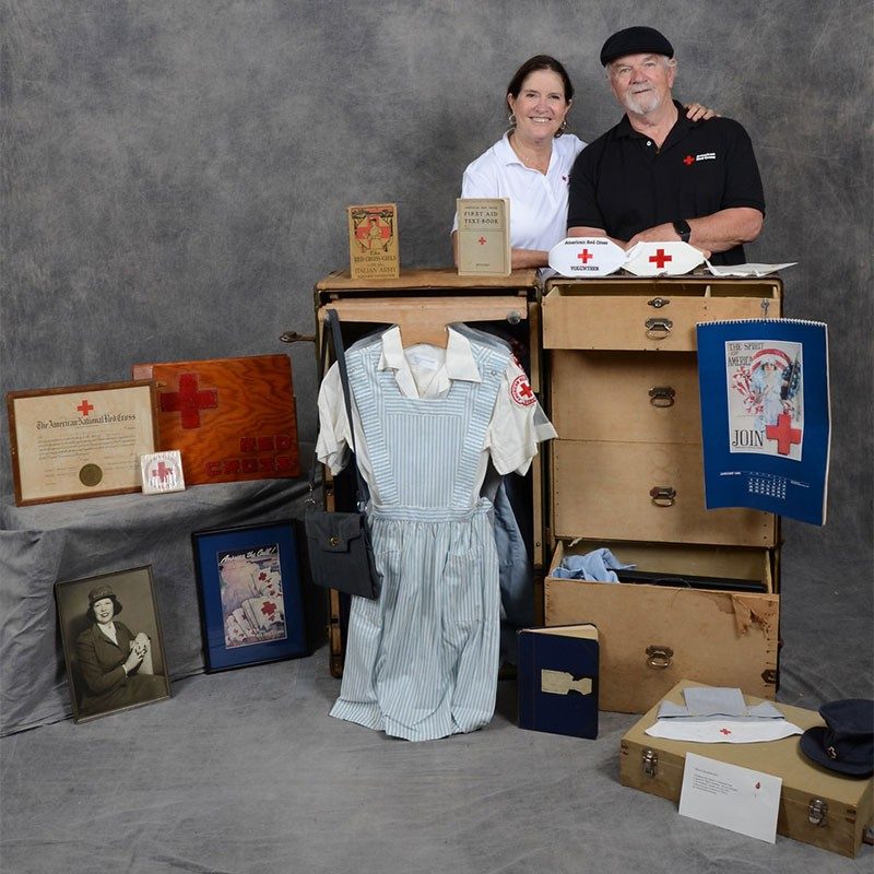 Red Cross volunteers with items from time capsule.