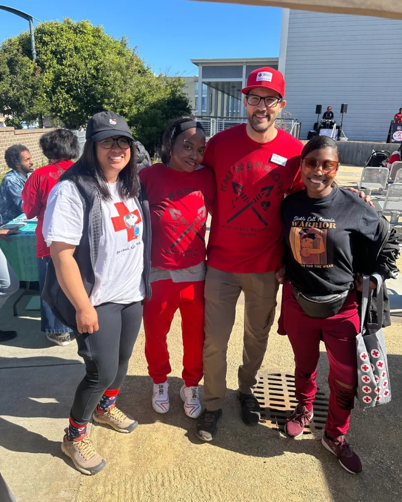 justin posing with biomed staff at event