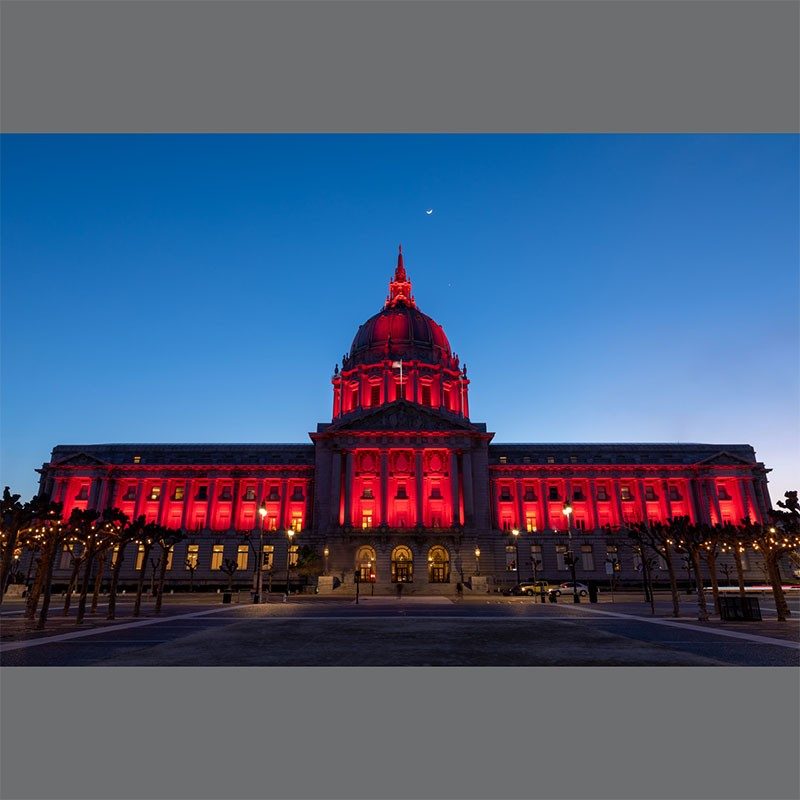 Building lit up red at night.