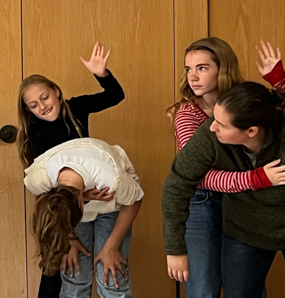 Piper Hanson and Natalie Malas practice first aid response to choking on Berkeley Rahn and Instructor Robyn Bruton.