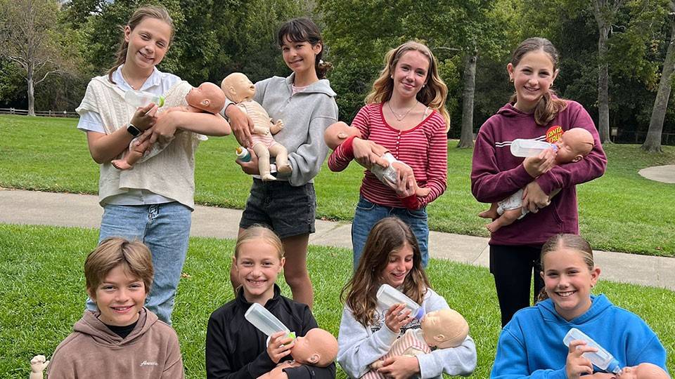 Berkeley Rahn, Paula Luzardo, Natalie Malas, Eloise Green, Trey Roost, Piper Hanson, Simone Gendreau and Molly Foster hold mannequin babies during Red Cross Babysitter’s Training course at Marinwood Community Center in San Rafael, Calif.
