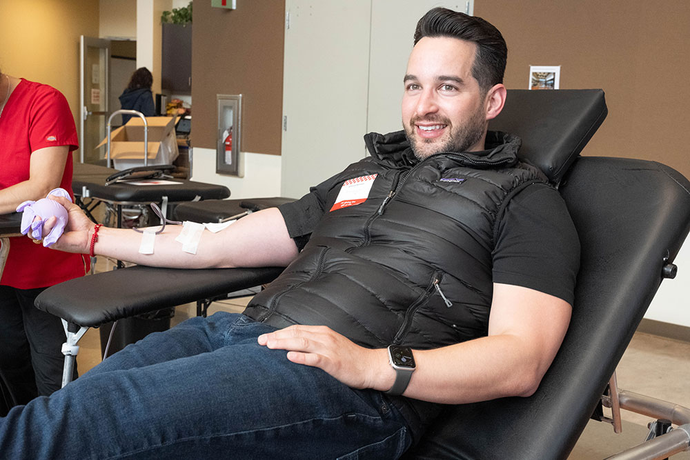 Councilmember Candelas sitting in chair and donating blood.