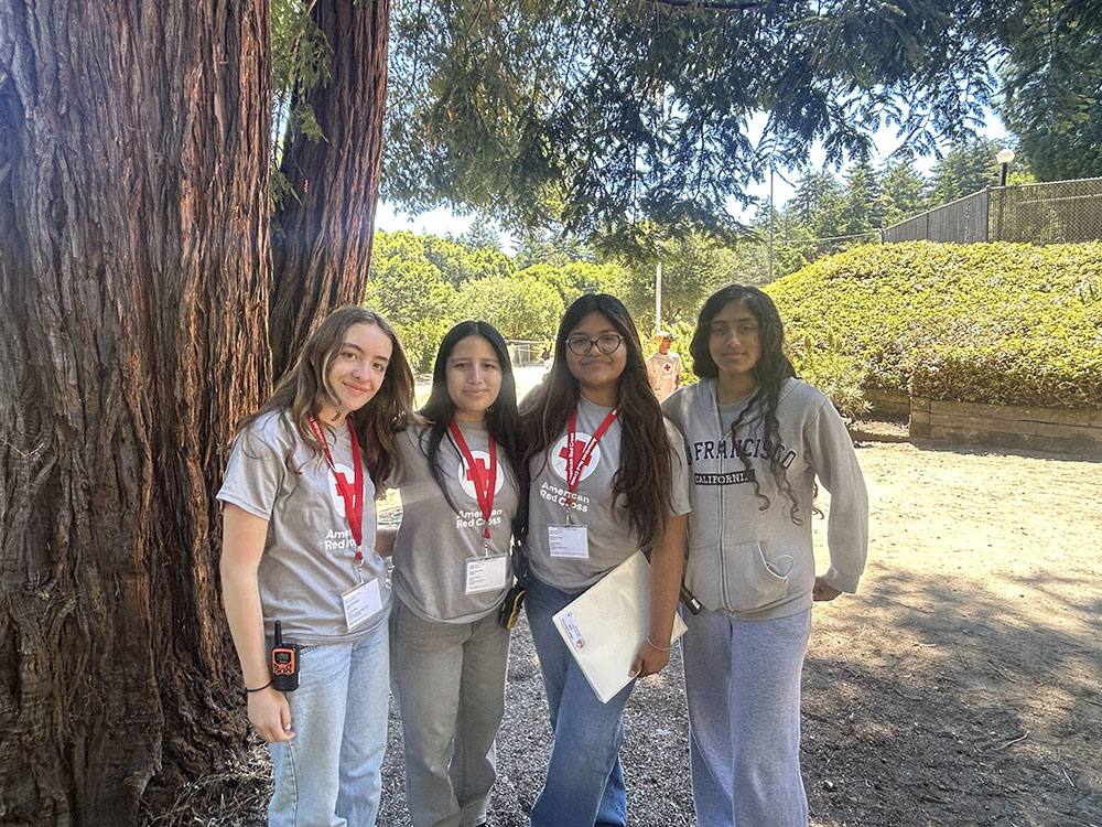A group photo of the Leadership Development Center staff under the shade of a tree.