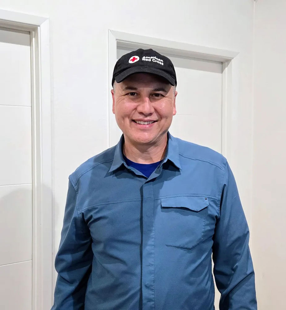 Dr. Justin Nast wearing a Red Cross hat.